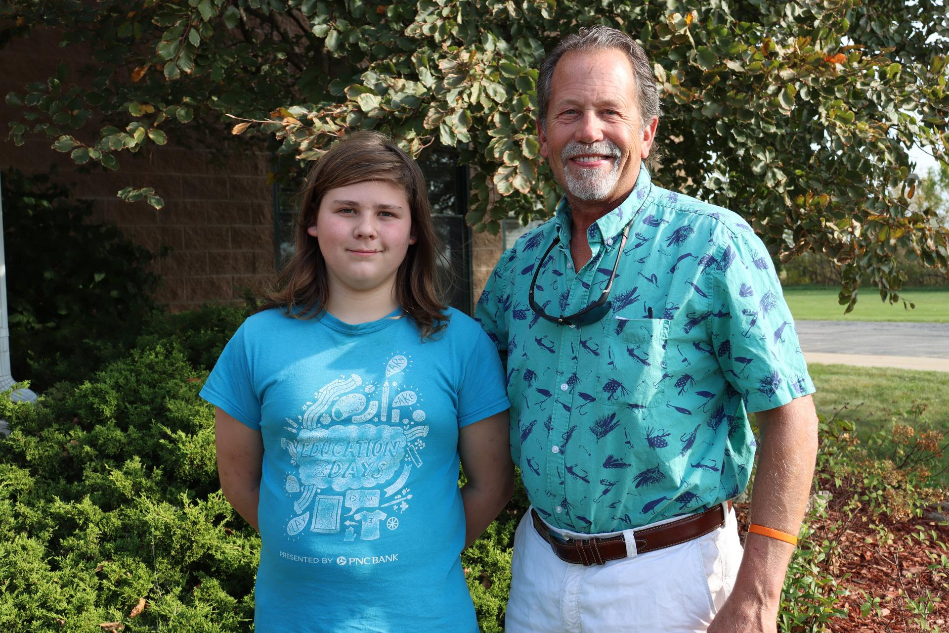 Mentee and mentor pair - Kurt & Anthony, standing outside in front of a tree