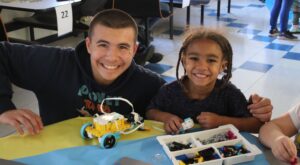 Smiling man and boy playing with Legos at a Lights On Afterschool Event