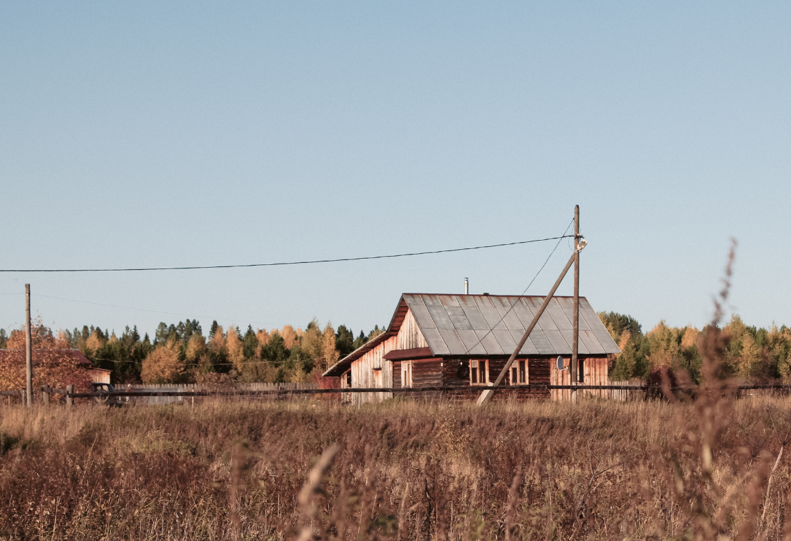 Picture of a farm home in the middle of the field, representing rural Michigan housing.